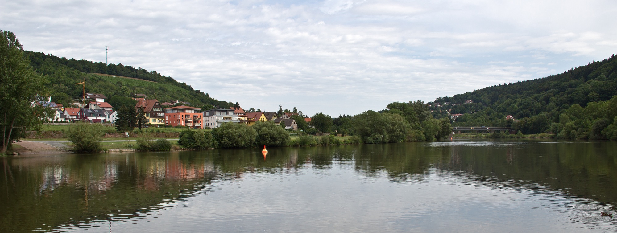 Panoramic shot of the still lake and view of the old city of Wertheim, Germany